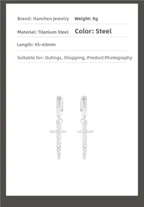 Detail of silver titanium steel cross earrings with zircon pavé and triple fringe chains