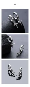 Detail of silver hoop earrings featuring sparkling double cross pendants with cubic zirconia