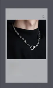 Close-up of silver lightning bolt necklace with hexagonal frame and heavy link chain