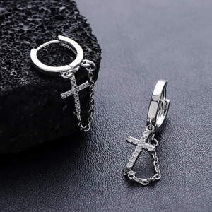 Silver cross drop earrings with pavé zircons on black lava rock and leather background