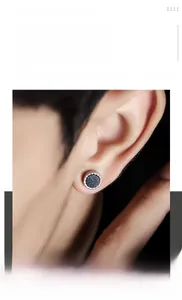 Close-up of minimalist black star-pattern titanium steel magnetic ear clip on model's ear