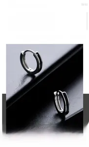 Macro detail of men's titanium steel hoop earrings with black enamel striped inlay