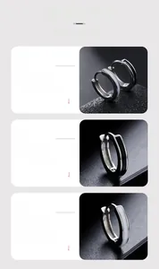 Macro detail of minimalist hoop earrings with black and white enamel drip design