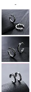 Macro view of silver-tone liquid metal ear cuffs with irregular wave texture