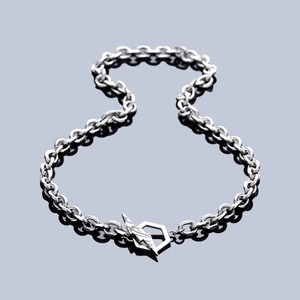 Industrial chunky chain necklace with a unique lightning hexagon clasp on dark mirror background