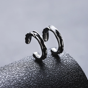 Minimalist silver irregular lava texture ear clips with sleek metallic finish and organic design