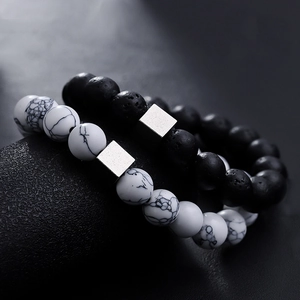 Volcanic stone and white turquoise bead bracelet set with geometric metal accents