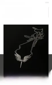 Close-up of titanium steel angel wing sword pendant necklace with sparkling rhinestones