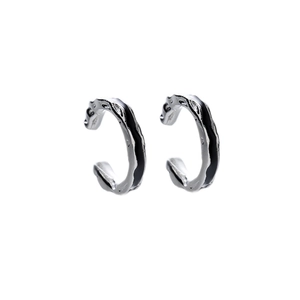 Minimalist silver ear clips with irregular lava texture and black enamel accents