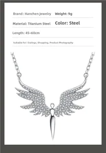 Detailed view of titanium steel angel wing necklace pendant with sparkling white zircons