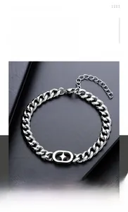 Detailed close-up of polished titanium steel Cuban link bracelet with star charm