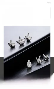 Macro shot of hip-hop gesture stud earrings in polished silver titanium steel