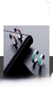 Macro view of C-shaped titanium steel ear clips with irregular texture and enamel oil