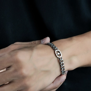 Polished titanium steel Cuban chain bracelet featuring a hollow star charm for men and women