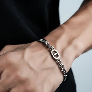 Men's silver titanium steel cuban link bracelet with hollow star charm on wrist