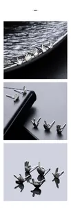 Macro view of five-piece silver gesture earrings set on a reflective black leather base