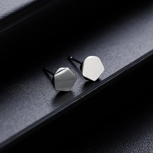 Minimalist silver hexagon stud earrings with polished geometric metal finish