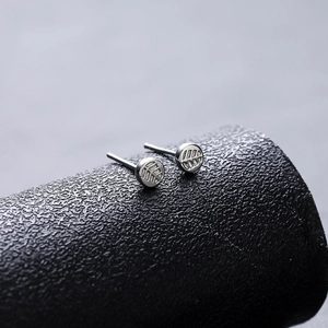Minimalist maple leaf pattern stud earrings with polished silver textured finish