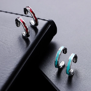 Irregular textured silver ear cuffs with red and blue enamel in a lava design
