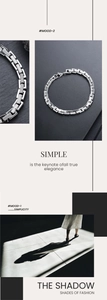 Macro detail of silver titanium steel chain link bracelet with classic watch band design
