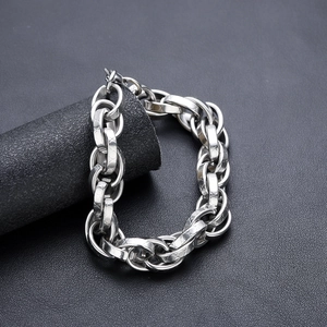 Polished silver chunky titanium steel chain bracelet on a minimalist black display