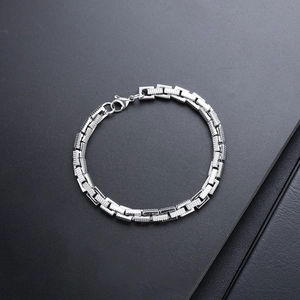 Titanium steel bracelet featuring rectangular engraved links and a secure lobster clasp