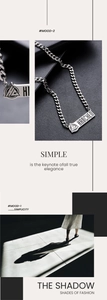 Detailed view of silver titanium steel Cuban chain necklace with engraved rectangle tag