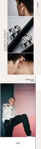 Detail of stacked black and silver curved ear cuffs with brushed metal texture