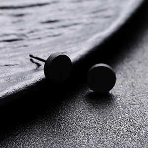 Minimalist matte black round stud earrings for men and women in industrial style