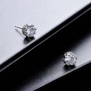 Classic silver crown stud earrings with clear zircon stones on black leather stand