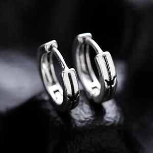 Silver huggie earrings with butterfly engraving on black stone base in high contrast