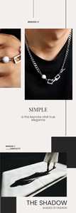 Detail of silver-tone natural stone necklace with crackled marble bead and chunky cuban chain