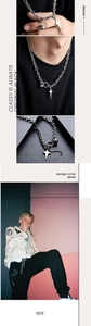 Detail of street style industrial silver cross star necklace with metal ball on thick chain