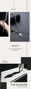 Detail of silver star pendant necklace with chunky links and minimalist tassel beads