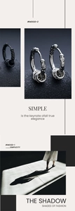 Detail of vintage embossed hoop earrings with metal rings in silver and matte black finish
