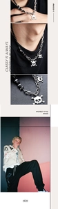 Close-up of punk skull pendant necklace with mixed metal chain and dark street style details
