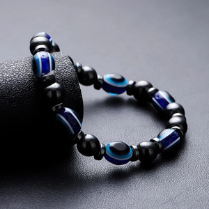 Minimalist evil eye beaded bracelet with glossy black hematite and metal accents