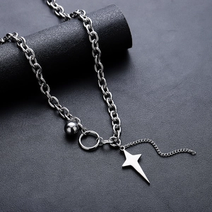 Unisex silver cross star necklace with ball pendant and chunky chain on display
