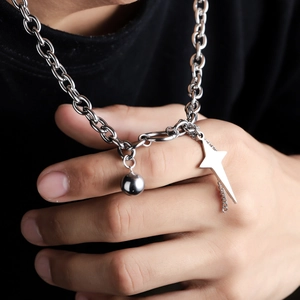 Silver punk chain necklace featuring a polished ball and star pendant on a black tee