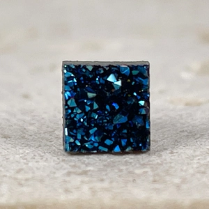 Close-up of square magnetic earring with deep blue druzy crystal texture and matte finish