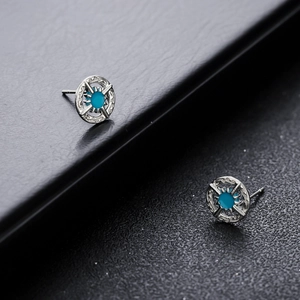 Silver north star stud earrings featuring turquoise inlay with vintage geometric engraving