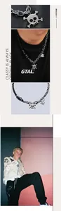 Detail showing mixed metal skull pendant necklace with black Cuban link and silver chain