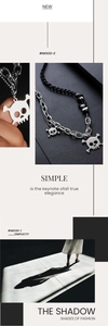 Detail of punk style skull pendant necklace with mixed metal chains and black beads