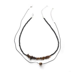 Double-layered necklace with tiger eye stones and black beads on white background