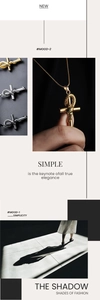 Detail of snake entwined cross necklace with green stone eyes in gold, silver and black