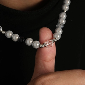 Collier en acier titane pour hommes avec perles grises et noires sur tricot noir