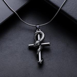 Gothic Ankh cross necklace with carved snake pendant on black leather background