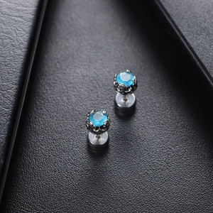 Titanium steel stud earrings featuring round blue zircon stones in black crown settings