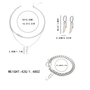 Silver feather necklace and bracelet set with engraving details on a white background