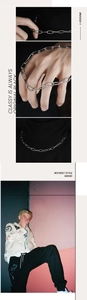 Close-up of polished silver oval link chain shown as a necklace on a street style model